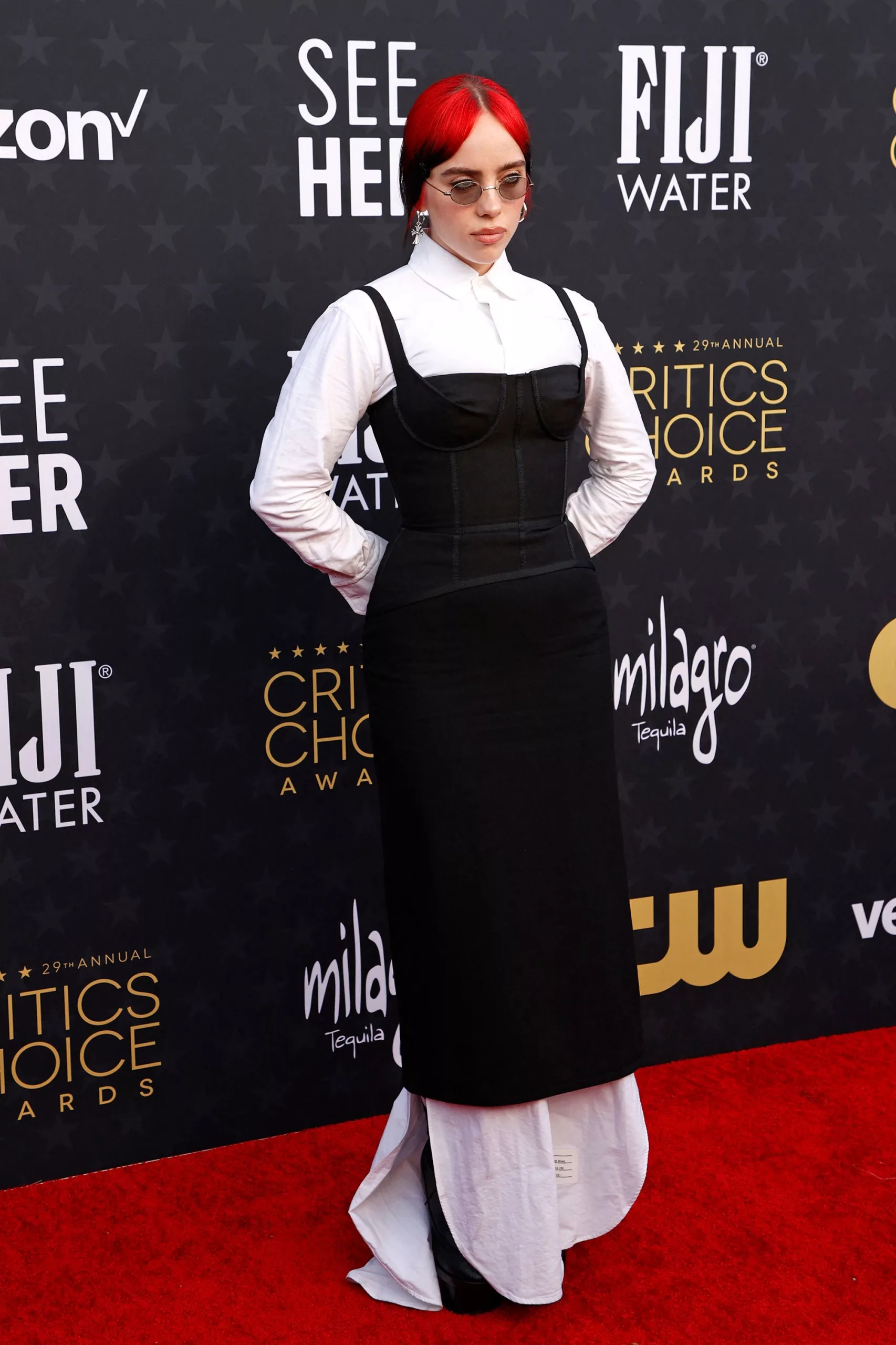 Billie Eilish wore a Thom Browne look comprising a white floor-length shirtdress beneath a little black dress with structured bodice.