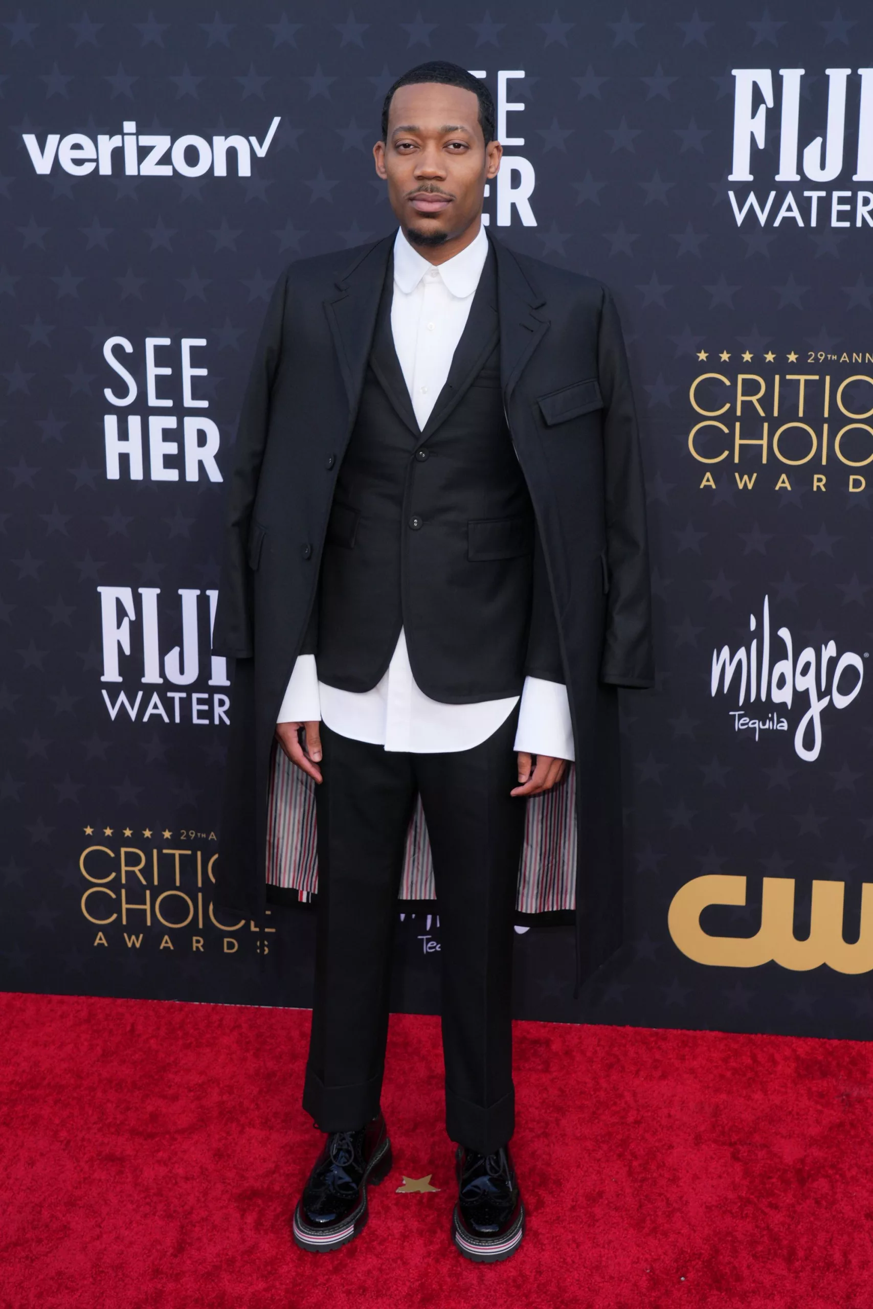 “Abbott Elementary” star Tyler James Williams wore a black Thom Browne suit with a candy stripe lining and matching brogues.
