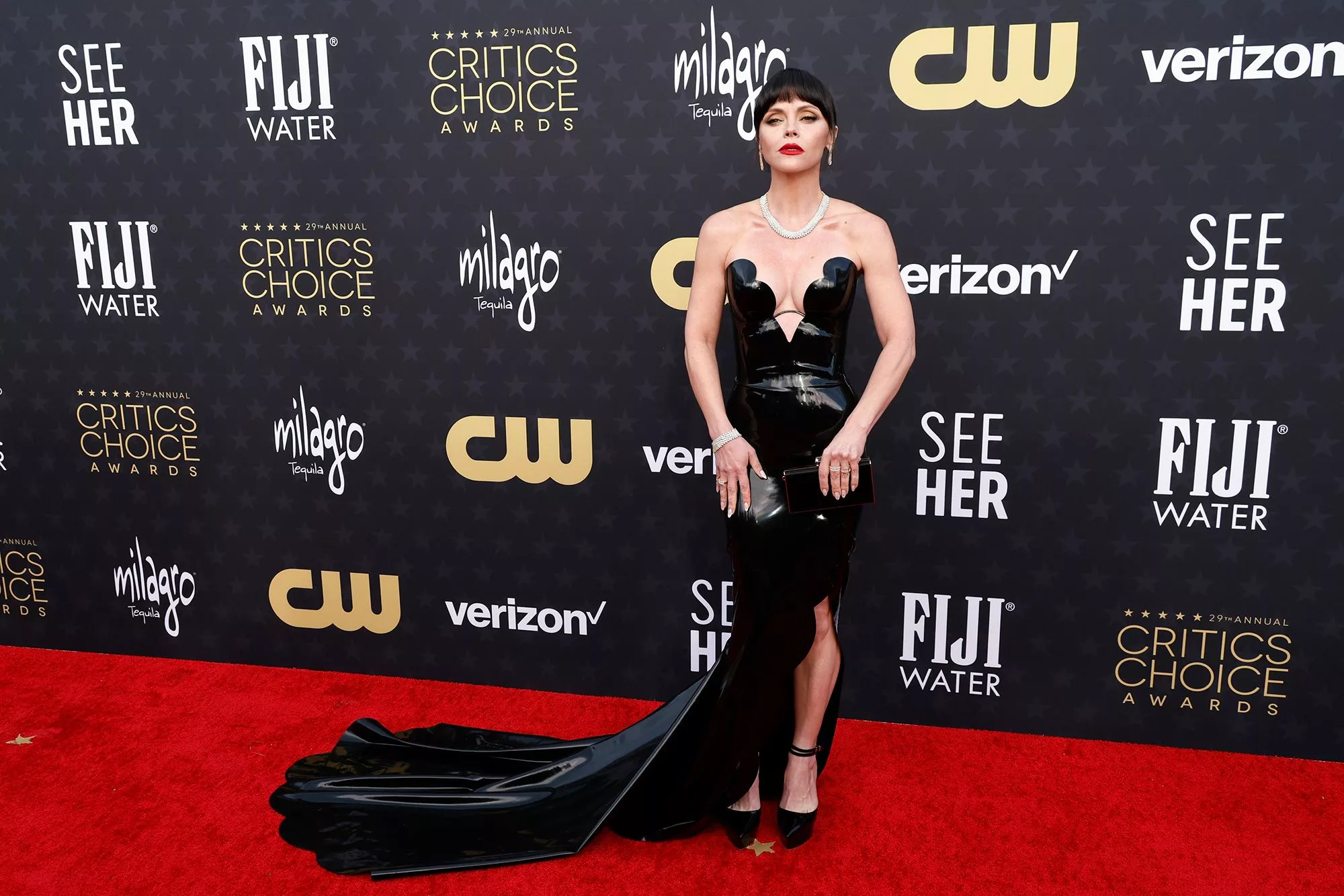 Christina Ricci channeled Morticia Addams with a black latex Atsuko Kudo dress with deep sweetheart neck. She completed the look with a Carolina Herrera clutch and diamond jewelry by Bucherer.