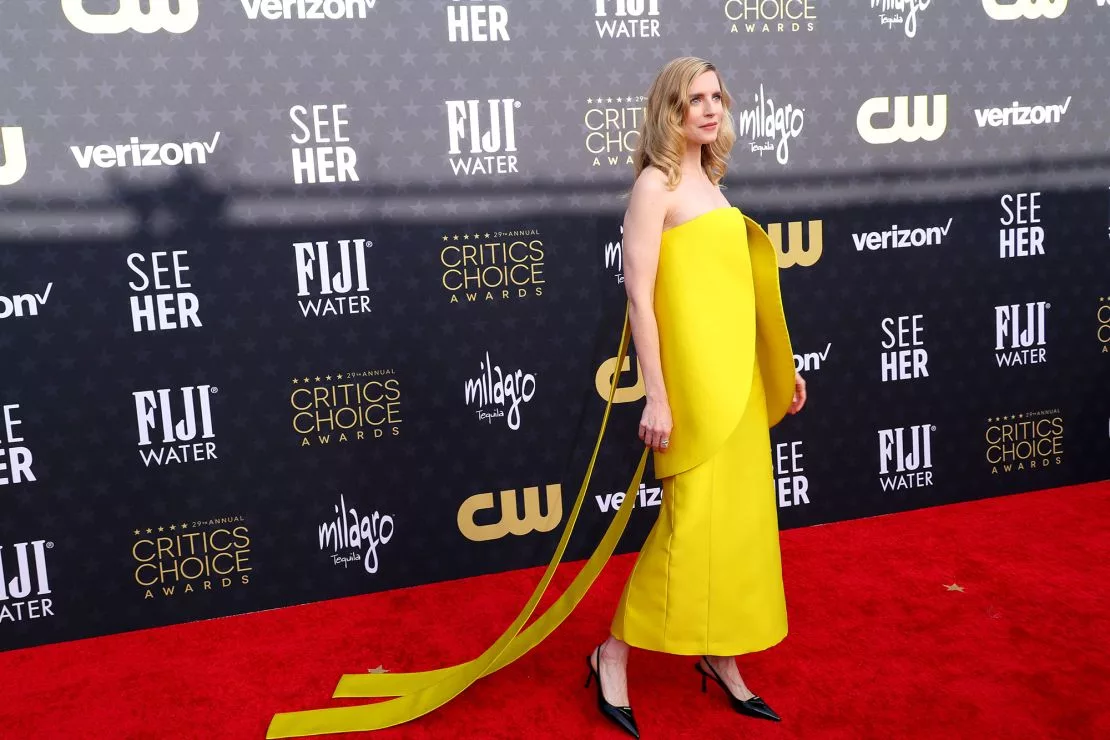 Actor Brit Marling was in head-to-toe Prada, including a yellow satin dress and black patent leather pumps.